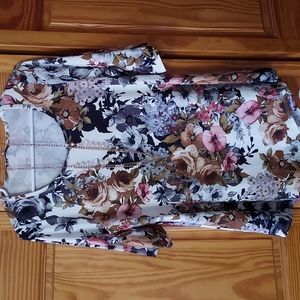 A blouse that includes a pretty necklace.